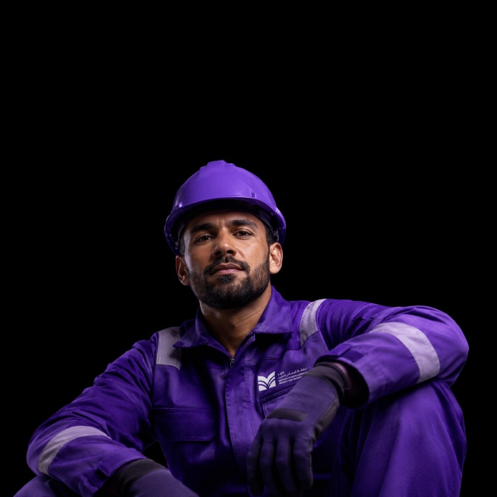 An IMRT trainee in institute workwear and a safety helmet.